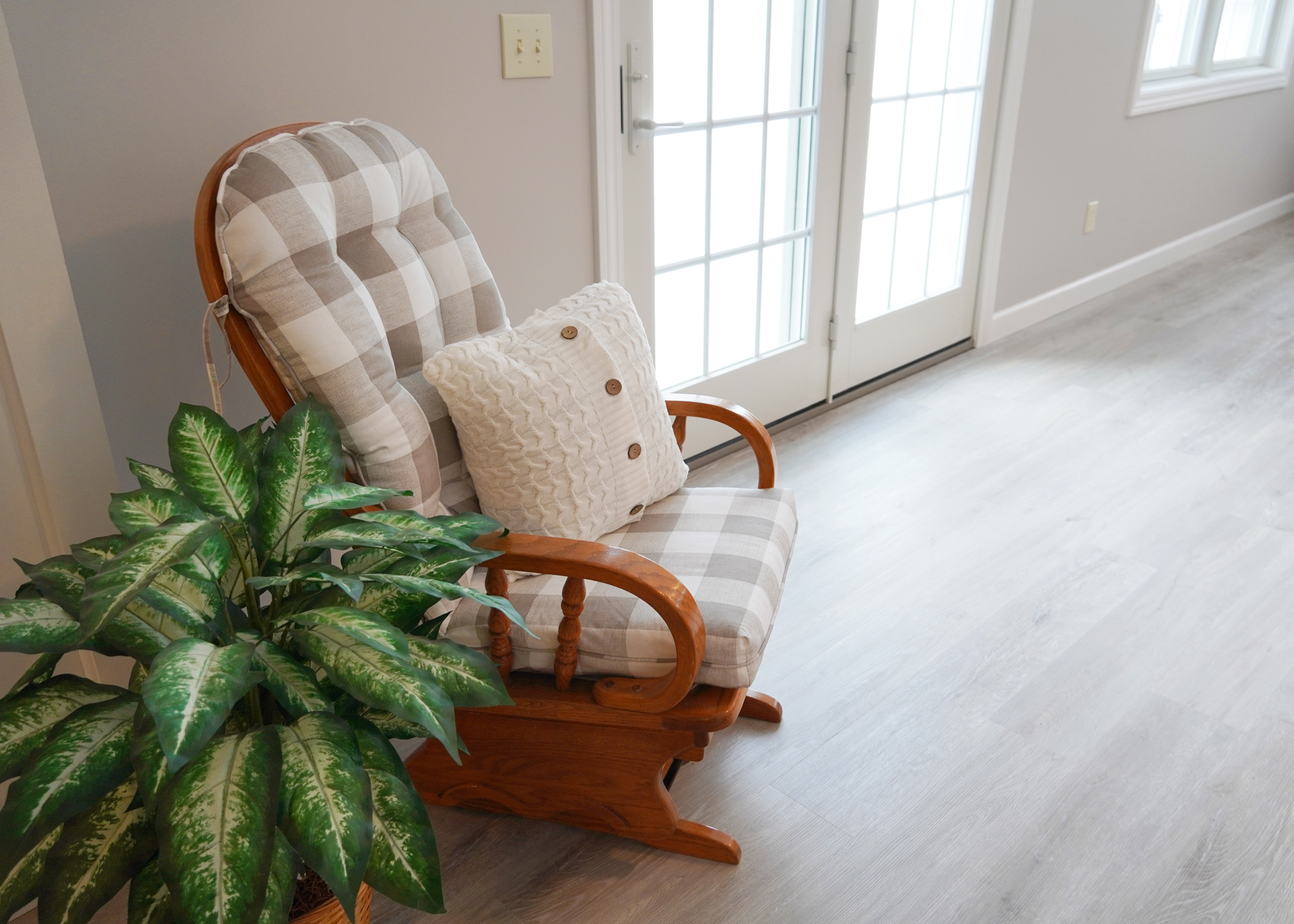 Rocker chair and plant on vinyl plank flooring